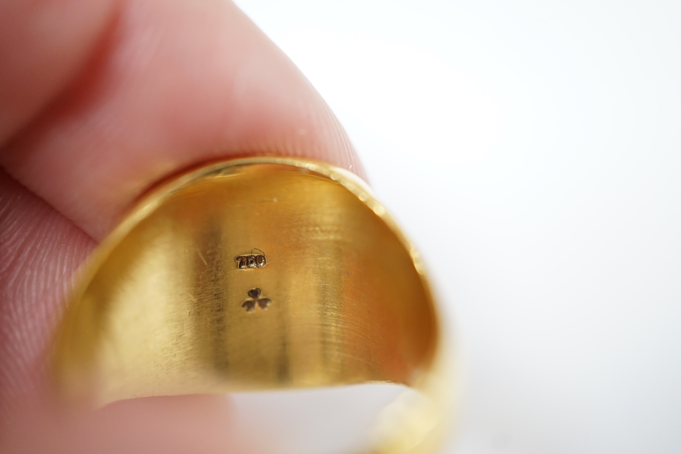 A 750 yellow metal signet ring, size N